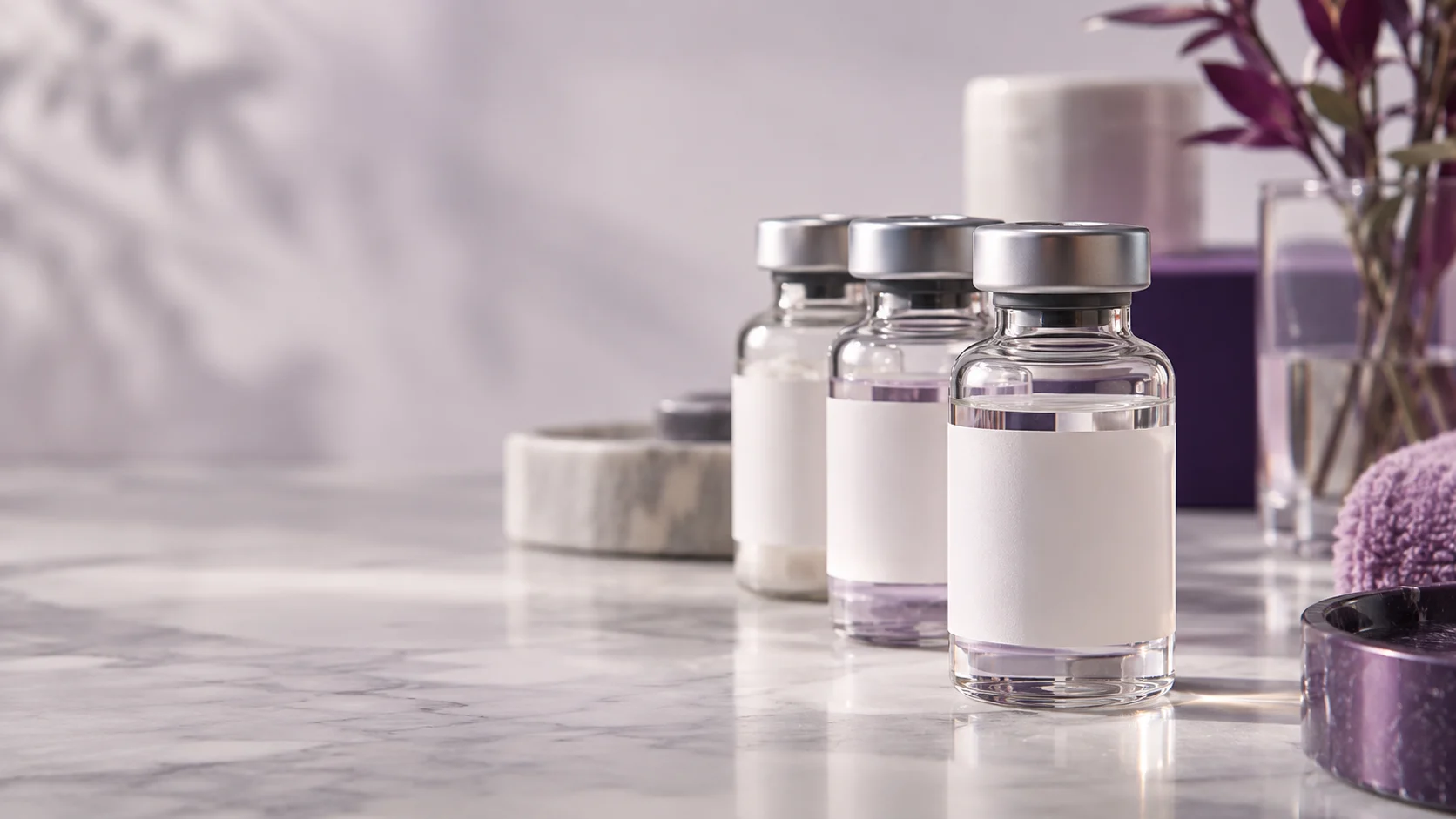 A row of sealed glass bottles with neutral white labels — project illustration