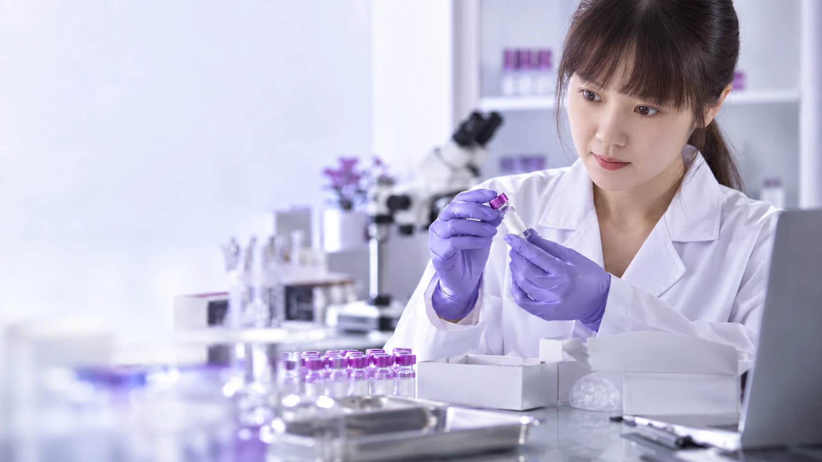 East asian scientist inspecting sample identity labels — project illustration